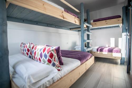 two bunk beds in a room with wooden floors at Cielo in Sierra Nevada