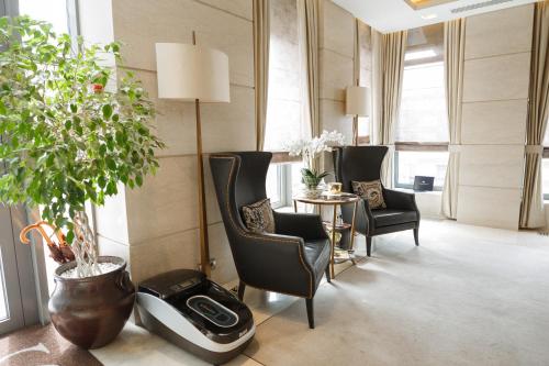 a living room with chairs and a table and plants at SOHO boutique hotel in Dnipro