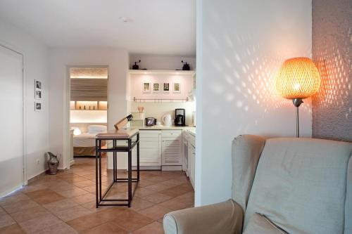 a living room with a table and a kitchen at Dionysos Village Hotel Marmaris in Turunc