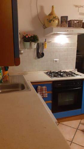 a kitchen with a stove and a sink at Casa Coiri in Cairo Montenotte