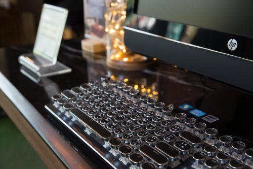 a computer keyboard sitting on top of a counter at Botanic Service Room at Impact Muangthongthani - SHA Certified in Nonthaburi