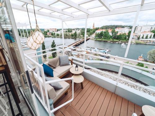 a balcony on a ship with a view of a river at Original Sokos Hotel Seurahuone Savonlinna in Savonlinna