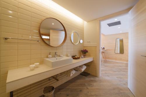 a bathroom with a sink and a mirror at Rinoterra Minho in Caminha