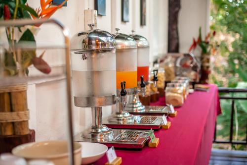 a table with a pink table cloth with drinks on it at The Vatika Resort and Spa in Ao Nang Beach