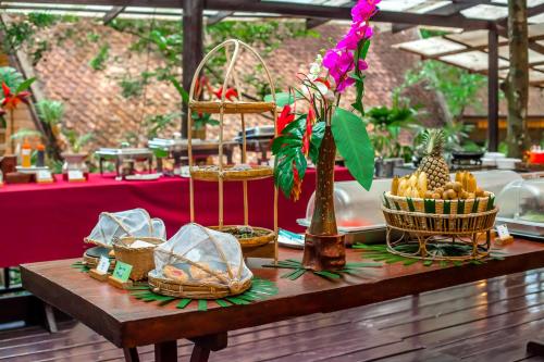 a wooden table with baskets of food on it at The Vatika Resort and Spa in Ao Nang Beach