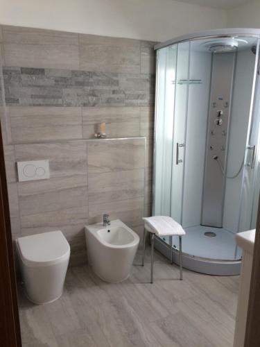 a bathroom with a shower and a toilet and a sink at Da Alsido in Camporosso in Valcanale