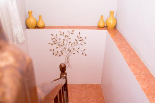 a group of vases sitting on top of a wall at Villa Prince in Harare