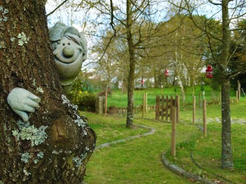 a stuffed teddy bear is attached to a tree at Casa Das Palmeiras-Pedagogic Farm in Mangualde