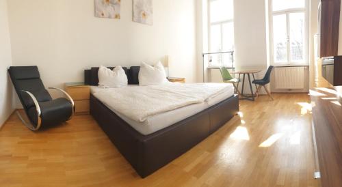 a bedroom with a bed and a table and chairs at Studio Allerheilgenplatz in Vienna