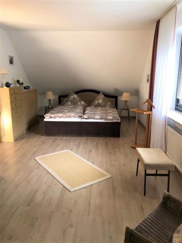 a bedroom with a bed and a rug on the floor at Ferienwohnung Will in Walkenried