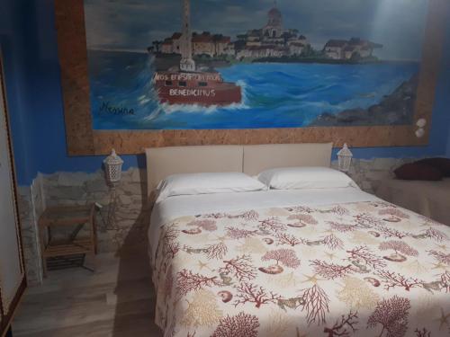a bedroom with a bed with a painting on the wall at Sicilia In Miniatura "L'Atelier dell'Etna" in Zafferana Etnea