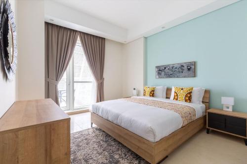 a bedroom with a bed and a large window at Frank Porter - Mon Reve in Dubai