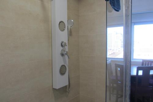 a shower with a glass door in a bathroom at Quiet Studio City Center in Porto