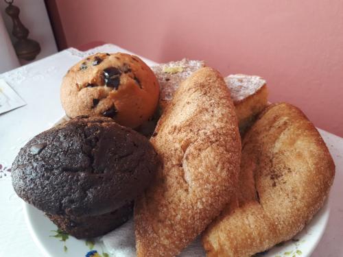 a plate of cookies and muffins on a table at Sicilia In Miniatura "L'Atelier dell'Etna" in Zafferana Etnea