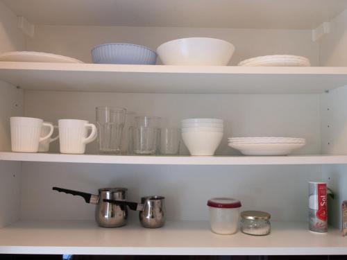 a shelf with bowls and cups and other dishes at Silba Otium in Silba