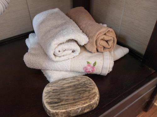 a pile of towels on a table next to a woodenomaly at Silba Otium in Silba