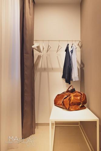 a bag sitting on a table in a closet at Marla's boutique rooms in Noto