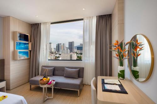 a hotel room with a couch and a table at DQua Hotel in Nha Trang