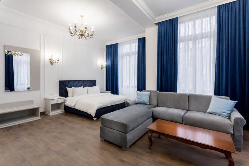 a living room with a couch and a bed at Lahovary Palace Hotel in Bucharest
