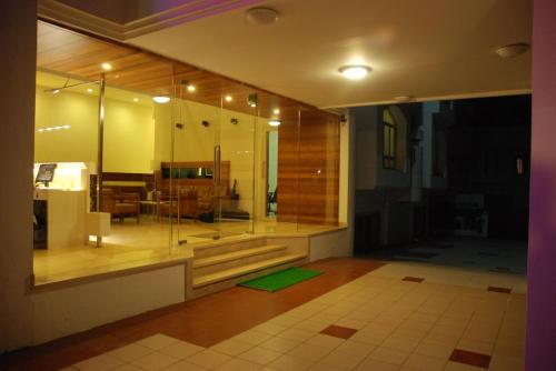 a room with a room with a glass wall at Hotel Rajtara in Satara