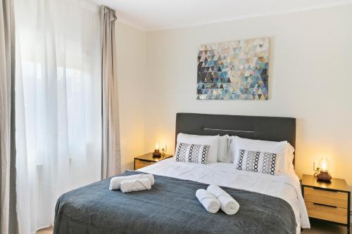 a bedroom with a large bed with two towels on it at Tendency Apartments Forum 4 in Barcelona