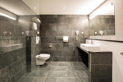 Ένα μπάνιο στο Bastion Hotel Apeldoorn Het Loo