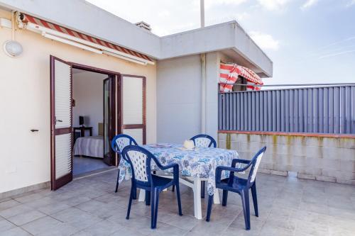 a table and chairs on the balcony of a house at Le Terrazze in Follonica