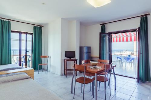 a room with a bed and a table with chairs at Le Terrazze in Follonica