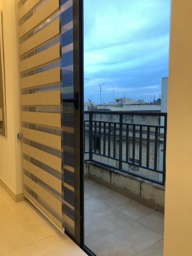 a door with a view of a balcony at Relax Zabbar in Żabbar