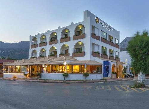 a hotel on a street in front of a building at Alianthos Beach Hotel in Plakias