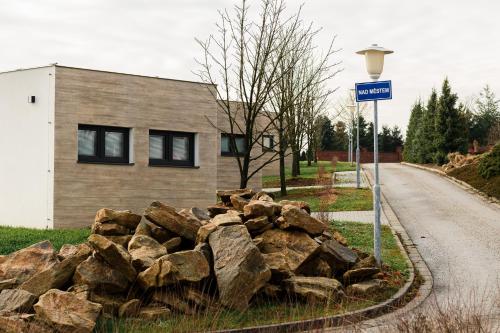 a pile of rocks sitting next to a street sign at Apartmány NMNM REZIDENCE NAD MĚSTEM in Nové Město na Moravě