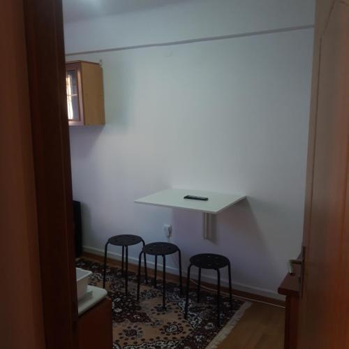 a room with four chairs and a white wall at RIO STUDIO in Sinaia