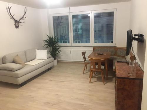 a living room with a couch and a table at Ferienwohnung neben dem Schloss Porcia in Spittal an der Drau