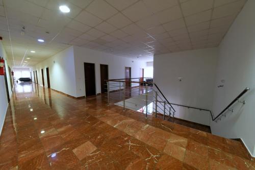 an empty hallway with a staircase in a building at Apartments & Rooms Krizevci in Križevci
