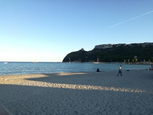 a group of people on a beach near the water at Villa Ingeborg in Quartu SantʼElena