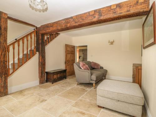 a living room with a couch and a chair at Copmanthorpe Hall in York