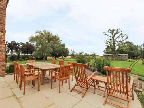 a wooden table and chairs on a patio at Copmanthorpe Hall in York
