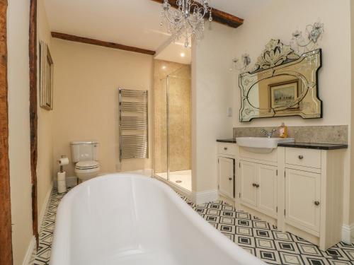a bathroom with a tub and a sink and a shower at Copmanthorpe Hall in York