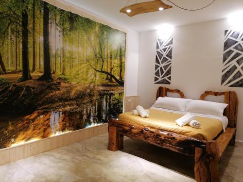 a bedroom with a large painting on the wall at Villa Sofia-La camera nella Riserva in Pettorano sul Gizio