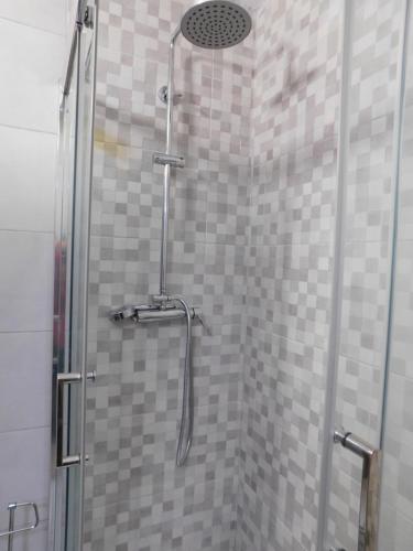 a shower with a glass door in a bathroom at Luz Beach Center in Luz