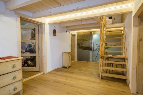 a room with a bunk bed and a ladder at Kummererhof in Itter