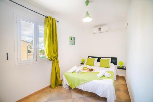a white room with a bed with a window at Villa Tucan Alcudia Cycling in Alcudia