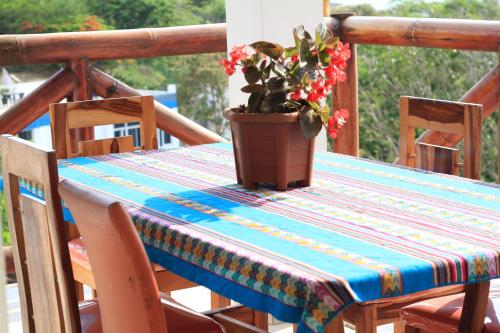 a table with a table cloth and a potted plant at The Heights in Montañita in Montañita