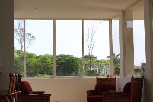 a group of windows in a room with chairs at The Heights in Montañita in Montañita