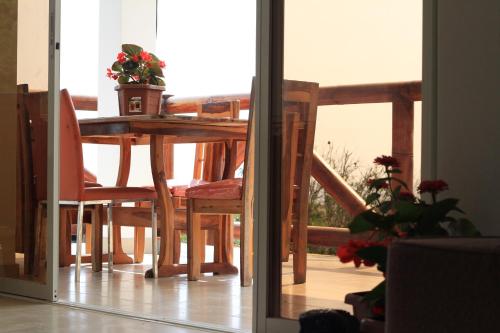 a dining room table with a potted plant on it at The Heights in Montañita in Montañita