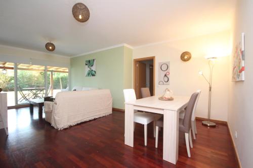 Schlafzimmer mit einem Bett, einem Tisch und Stühlen in der Unterkunft Atlantic Palm Garden Residence in Caniço