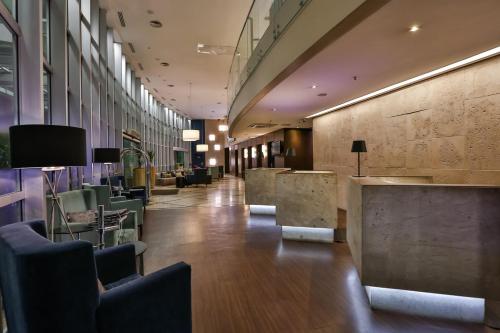a lobby of a building with chairs and a bar at Radisson Vila Olimpia Sao Paulo in Sao Paulo