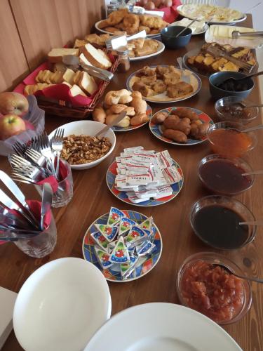 a table with many plates of food on it at Elova in Zátouna