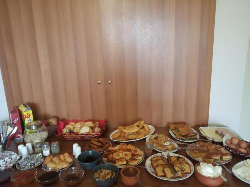 a table topped with plates of food and bread at Elova in Zátouna