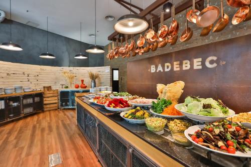 a buffet line with many plates of food at Radisson Vila Olimpia Sao Paulo in Sao Paulo